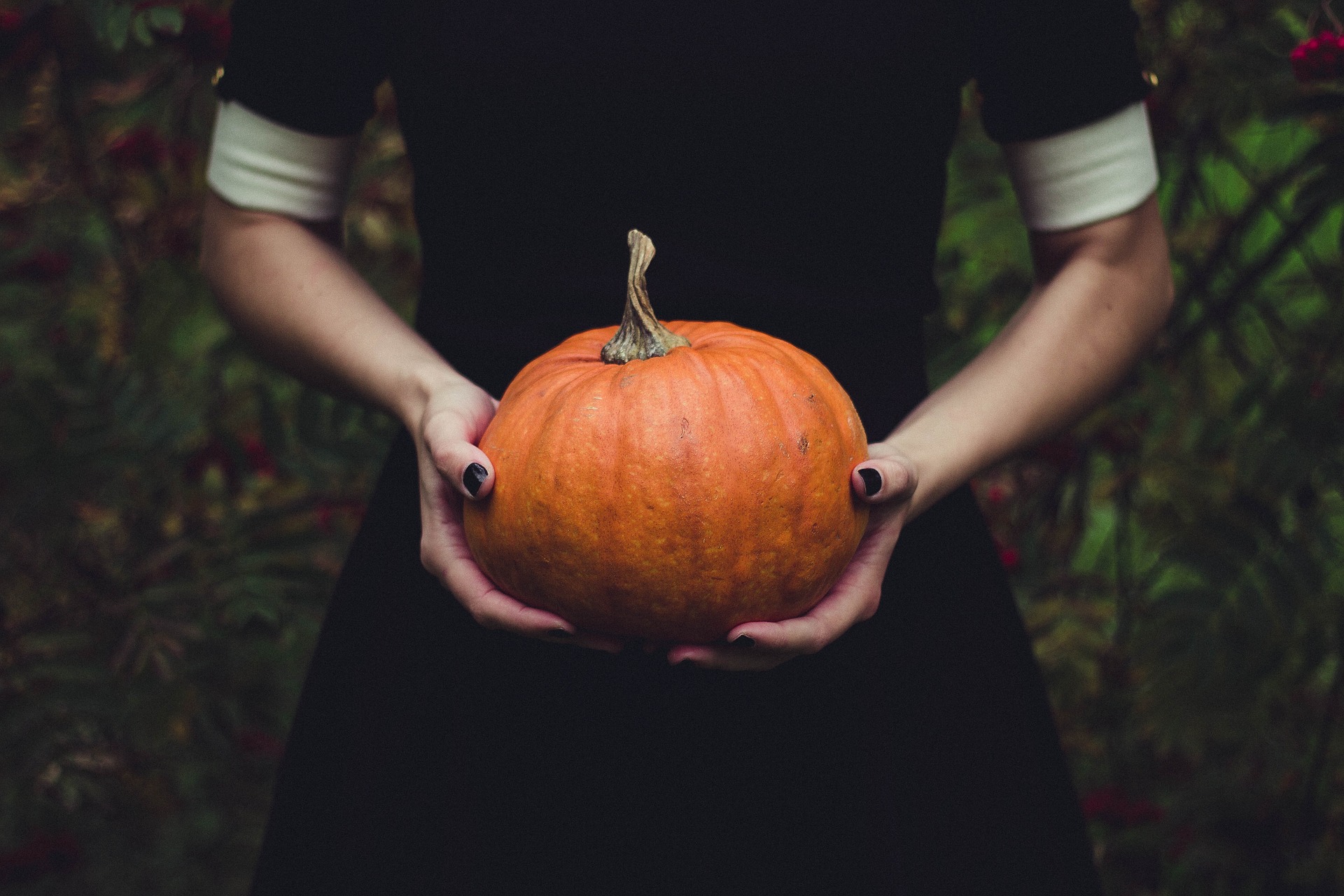 a lady holding pumpkin
